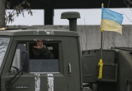 Member of the Ukrainian armed forces waves on a military vehicle near Artemivsk