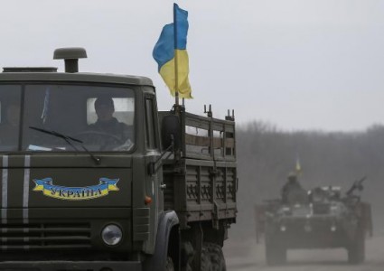 Members of the Ukrainian armed forces ride on military vehicles near Artemivsk