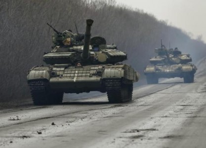 Members of the Ukrainian armed forces ride in tanks near Artemivsk