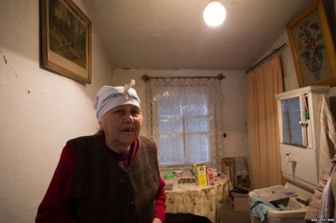 Nina Morozova vừa đươc tổ chức từ thiện Quốc tế tặng một tấm nhựa. Các cửa sổ trong căn hộ của bà đã bị bom đạn trong cuộc chiến phá vỡ.