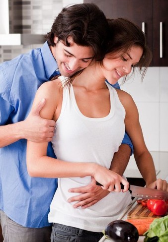 couple cooking and hugging