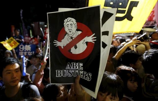 A protester holding a placard depicting Japan's Prime Minister Shinzo Abe takes part in a rally against Abe's security bill and his administration in front of the parliament in Tokyo, Japan, September 16, 2015. REUTERS/Yuya Shino